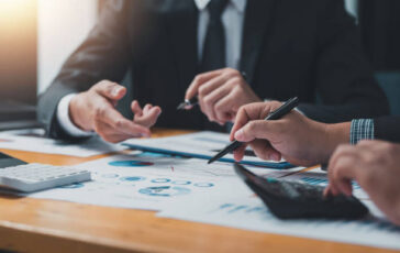 business people doing calculations analyze the work at the meeting business people doing calculations analyze the work at the meeting