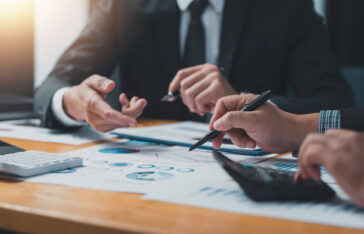 business people doing calculations analyze the work at the meeting