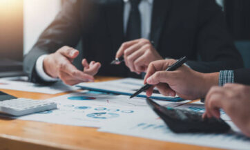 business people doing calculations analyze the work at the meeting